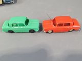 several toy cars are lined up on a table in a row