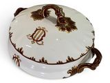 an image of a white and gold covered dish