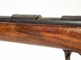a close up of a rifle on a white surface with a white background