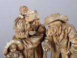 three figurines of a man and a woman and a child