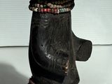 une petite statue représentant un ours coiffé d'un chapeau