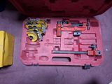 a red tool box with tools in it on the floor