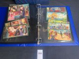 a blue binder with pictures of people on it