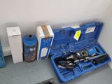 a blue case with tools in it sitting on the floor