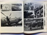 a book with pictures of airplanes in it on a table