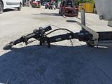 a tow truck with a trailer attached to the back of it