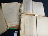 several old books are stacked on top of each other on a table