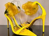 a close up of a pair of yellow shoes on a table