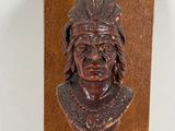 an image of a wooden sculpture of a native man