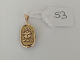 a gold pendant with a small bird on it