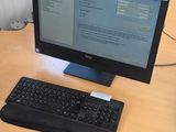 a desk with a computer, keyboard and mouse on it