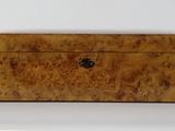 an old wooden box sitting on top of a white surface