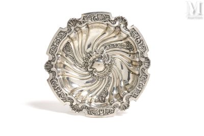 a close up of a silver plate on a white surface