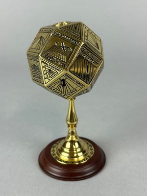 a brass plate with a wooden base and a wooden base