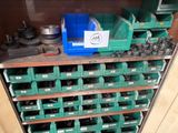 many green bins on the shelf in the garage