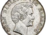 gros plan d'une pièce de monnaie sur laquelle figure un visage de femme