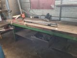 a man standing next to a workbench in a garage