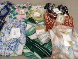 many different types of shirts that are on the floor