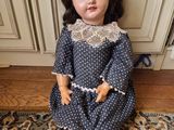 a doll that is sitting on a rug on the floor
