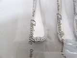three spoons that are sitting on a plastic bag