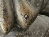 a close up of a statue of a person holding a banana
