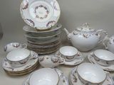 many plates and cups and saucers on the table