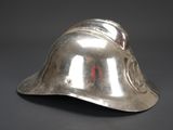 a silver helmet that is sitting on top of a table