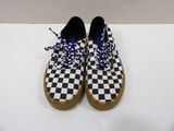 a pair of black and white checkered shoes with blue laces