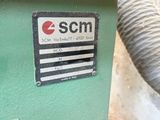 a machine that is sitting on the ground next to a wall