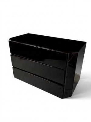 a black box with two drawers on it on a white surface
