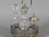 an antique silver plated salt and pepper shaker set with glass decanters