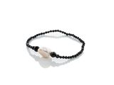 un gros plan d'un bracelet composé de perles noires et d'une perle blanche