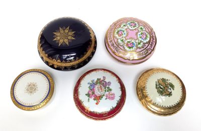 several different types of decorative boxes sitting on top of a white surface