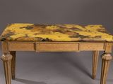 an old wooden table with a marble top on a gray background