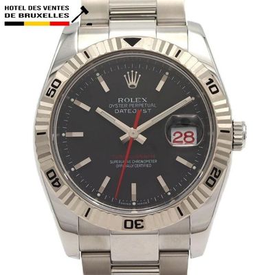 the rolex watch has a black dial and a red second hand