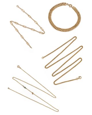 a group of gold chains and bracelets on a white background