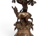 an image of a bronze candle holder with a bird on it