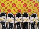 five pairs of shoes are lined up in front of a box