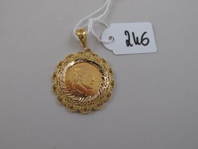a close up of a gold coin on a string with a price tag