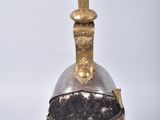 a helmet with a red feather on top of it