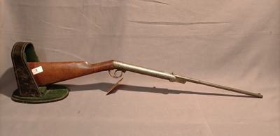 an old rifle with a wooden barrel on a white background
