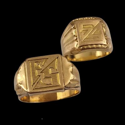 two gold rings with a cross on each of them on a black background