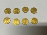 a collection of gold coins from around the world