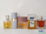 many different types of perfumes on a white table