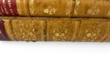 two old books stacked on top of each other