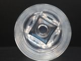 an image of a clear plastic object on a black surface