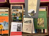 several books are stacked on top of each other in a box