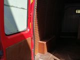 a red van with the door open and the back door open
