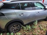 a silver car that is sitting in the grass