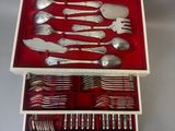 a red box with silverware in it on a table